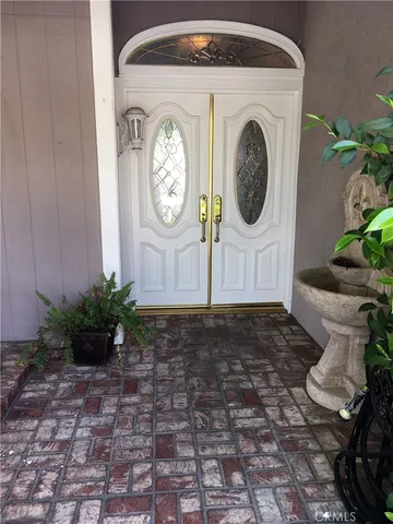 a view of a house with lots of potted plants