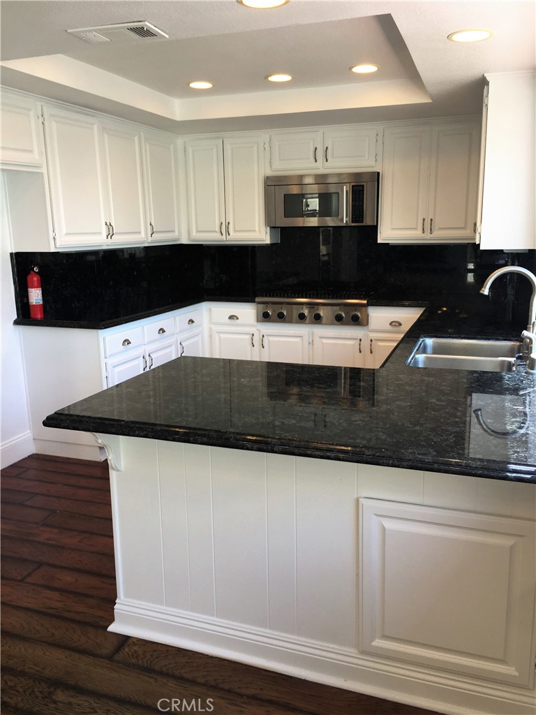 29022 Modjeska Peak Lane Lake Forest, CA 92679 - Photo 9 of 36 a kitchen with stainless steel appliances granite countertop a sink and a stove