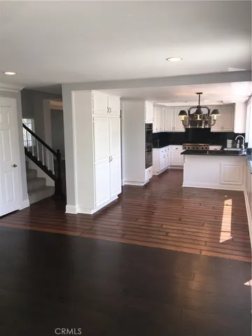 a view of kitchen with furniture and wooden floor