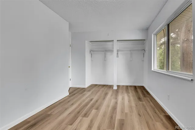 a view of a room with wooden floor and brick walls