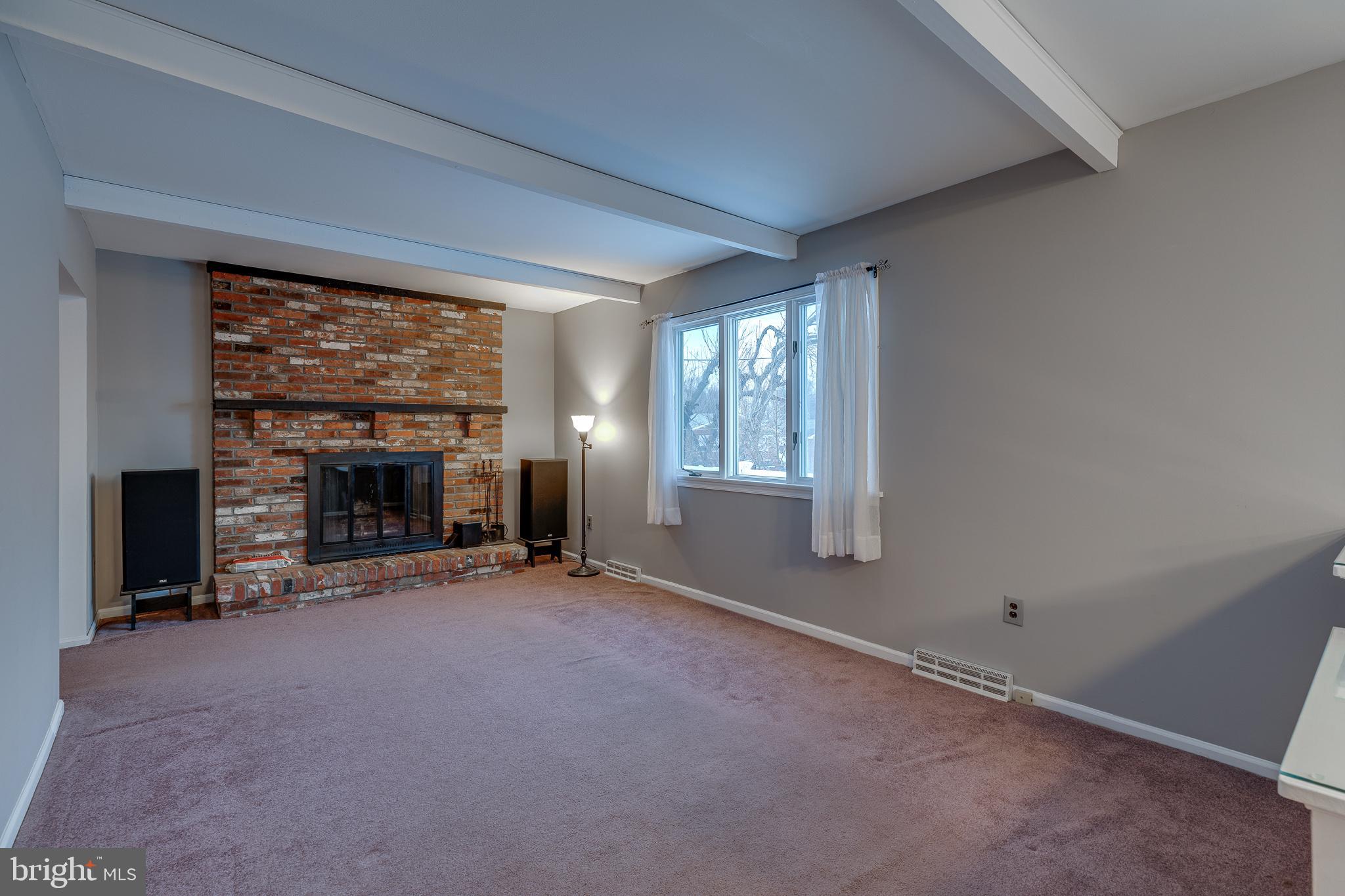 10963 Kipling Lane Philadelphia, PA 19154 - Photo 12 of 39 an empty room with floor to ceiling window and an fireplace
