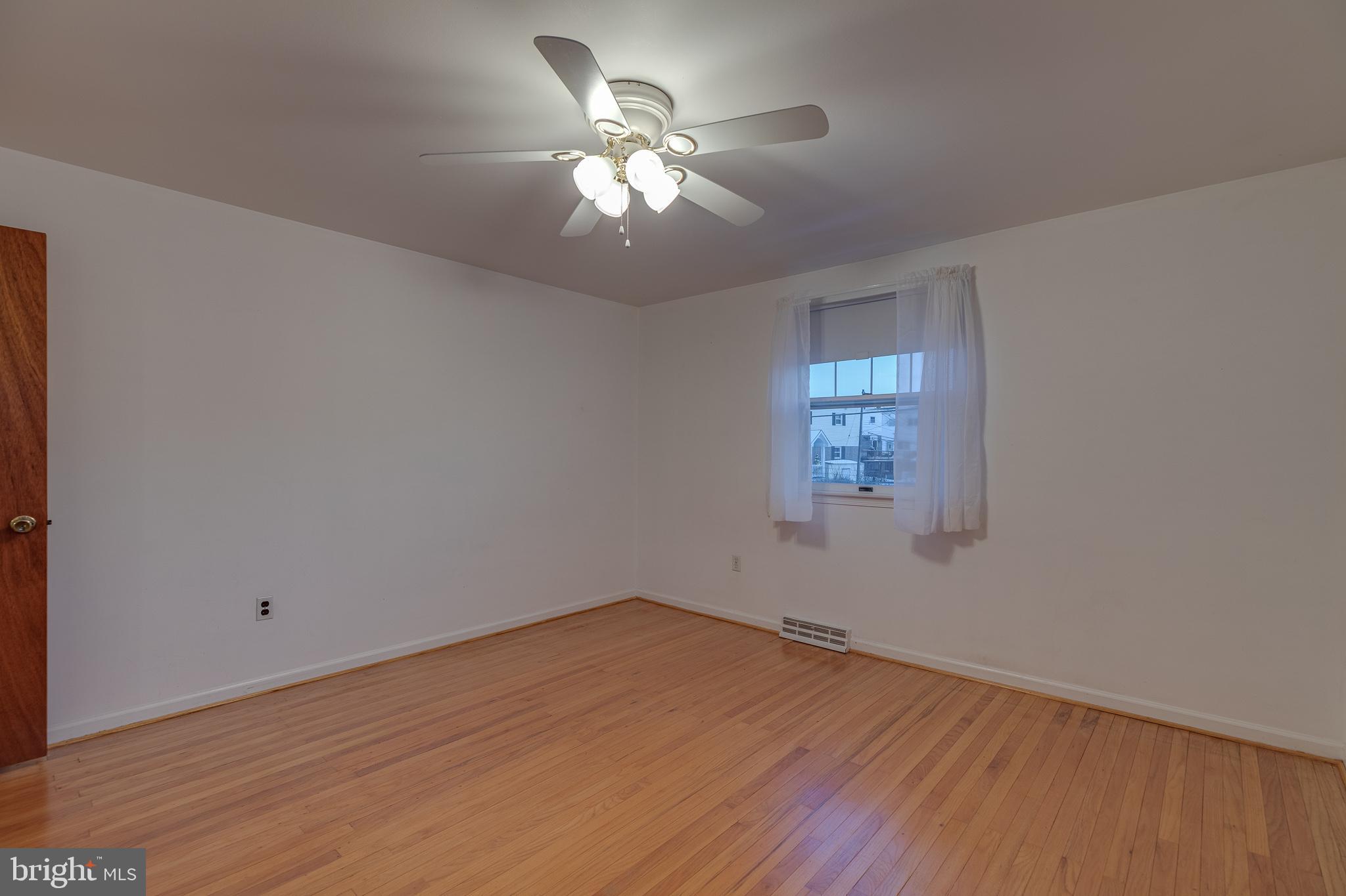 10963 Kipling Lane Philadelphia, PA 19154 - Photo 28 of 39 an empty room with wooden floor chandelier fan and windows
