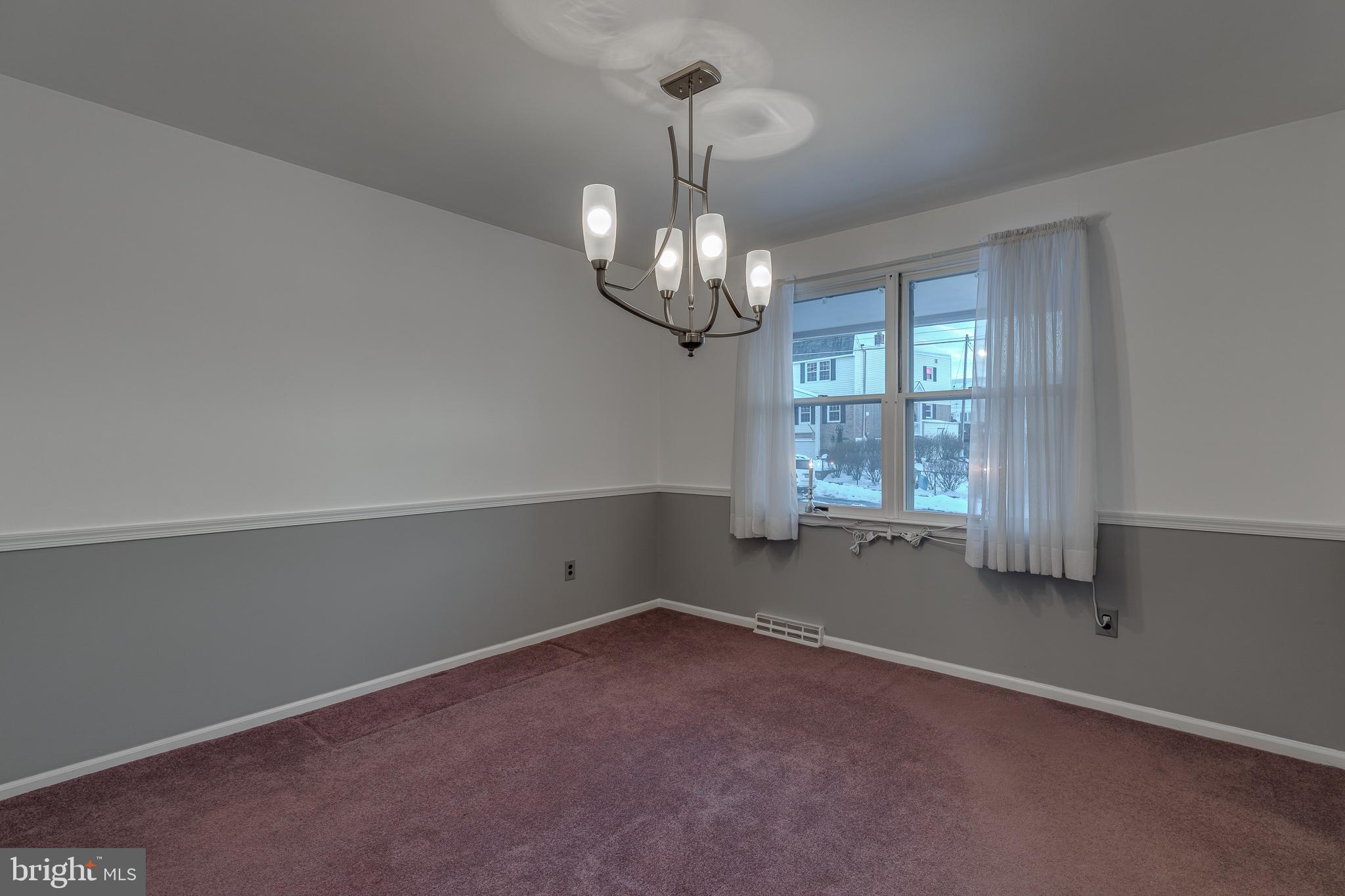 10963 Kipling Lane Philadelphia, PA 19154 - Photo 10 of 39 an empty room with windows and chandelier