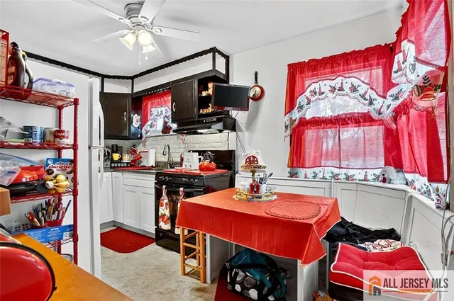 a living room with furniture a flat screen tv and a sink