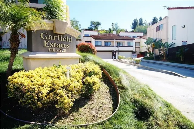 a view of a swimming pool with a patio and plants