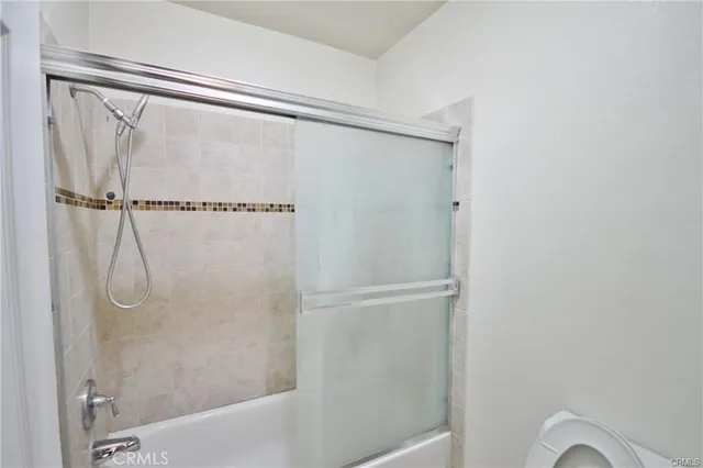a bathroom with a glass shower door