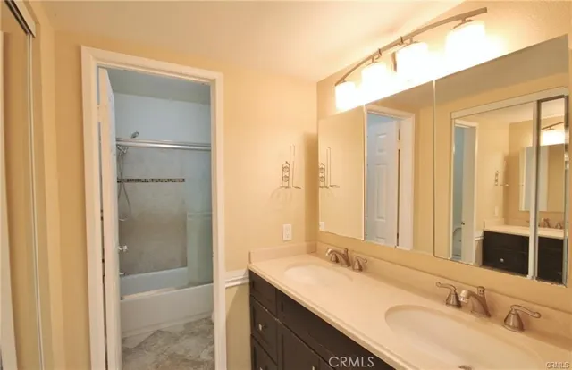 a bathroom with a double vanity sink mirror and double