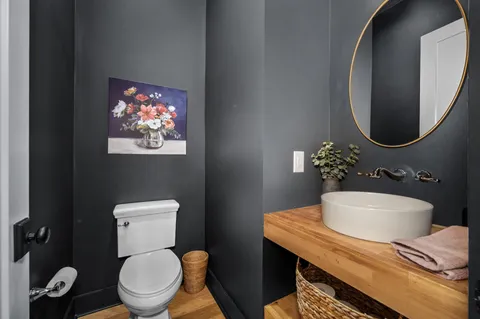 a bathroom with a toilet a sink and mirror