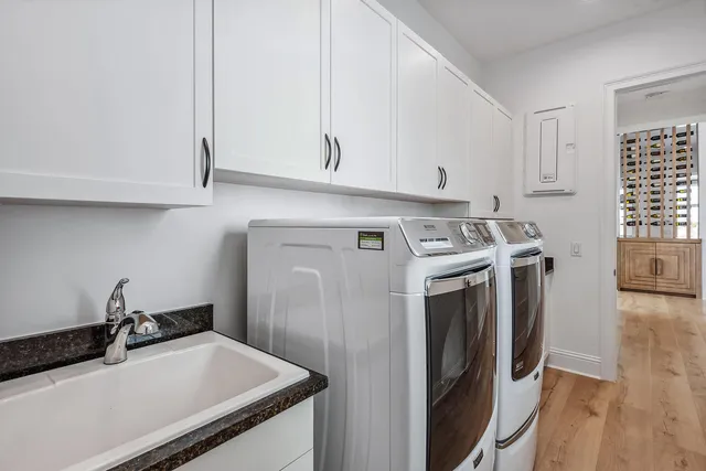 a kitchen with stainless steel appliances granite countertop a sink and a refrigerator