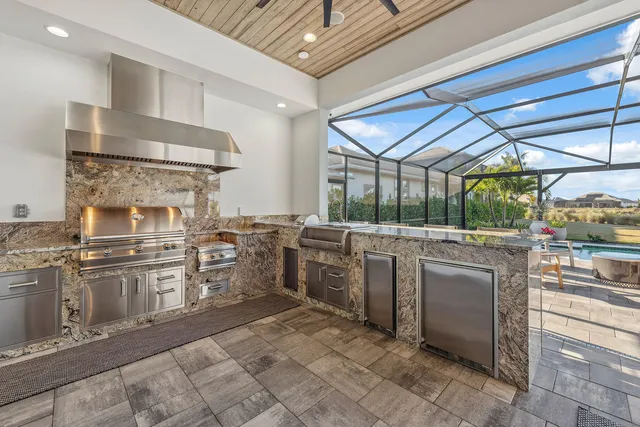 a kitchen with stainless steel appliances granite countertop a sink and cabinets
