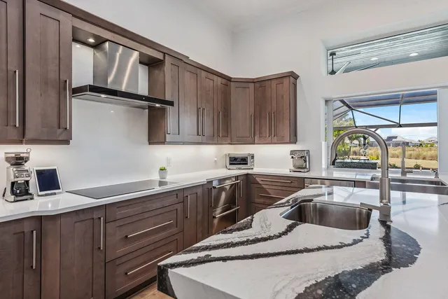 a kitchen with a sink cabinets and window