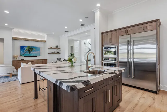 a kitchen with granite countertop a stove and a refrigerator