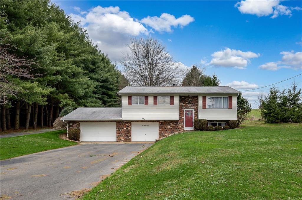 232 Pflugh Road Butler, PA 16001 - Photo 1 of 24 a front view of a house with a yard and garage