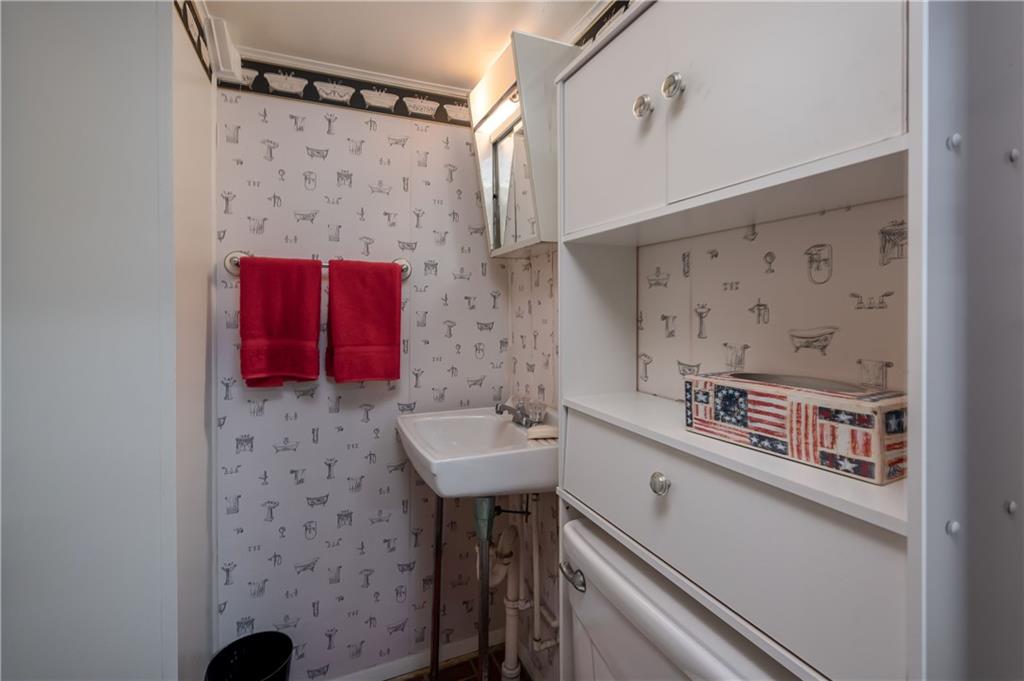 232 Pflugh Road Butler, PA 16001 - Photo 17 of 24 a bathroom with a sink a mirror and a shower