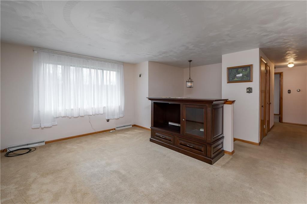 232 Pflugh Road Butler, PA 16001 - Photo 4 of 24 an empty room with fireplace and windows