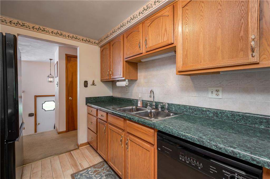 232 Pflugh Road Butler, PA 16001 - Photo 6 of 24 a kitchen with granite countertop stainless steel appliances a sink and cabinets