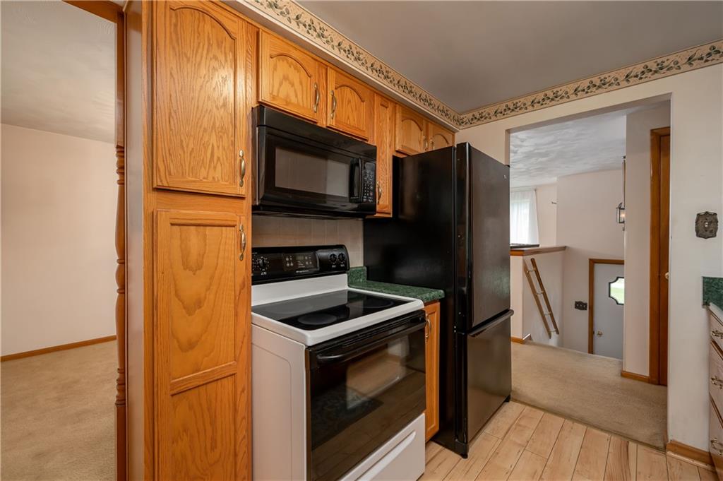 232 Pflugh Road Butler, PA 16001 - Photo 7 of 24 a kitchen with stainless steel appliances a refrigerator stove and microwave