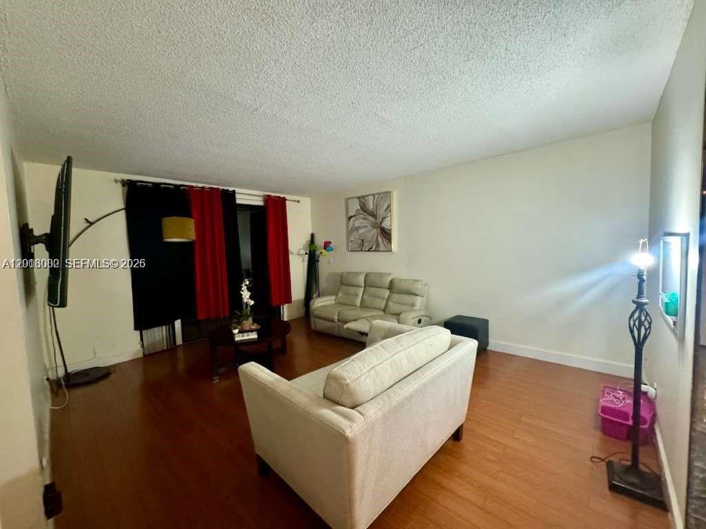 3730 Inverrary Drive, Unit 3B Lauderhill, FL 33319 - Photo 30 of 50 a living room with furniture and a wooden floor