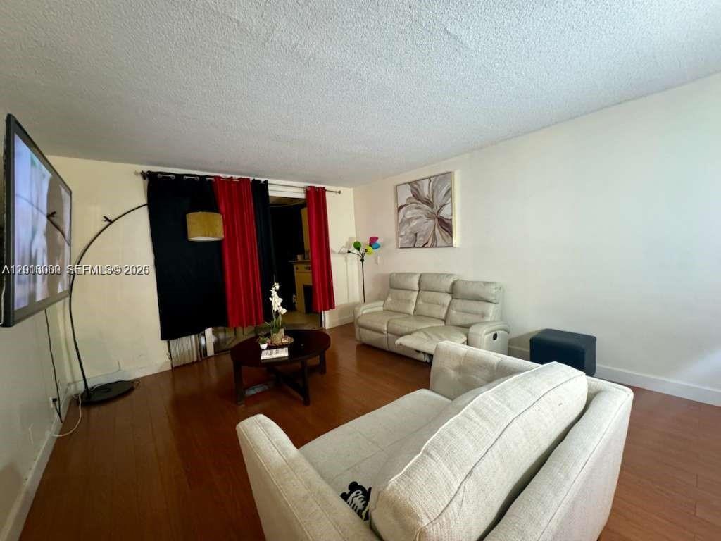3730 Inverrary Drive, Unit 3B Lauderhill, FL 33319 - Photo 31 of 50 a living room with furniture and a flat screen tv