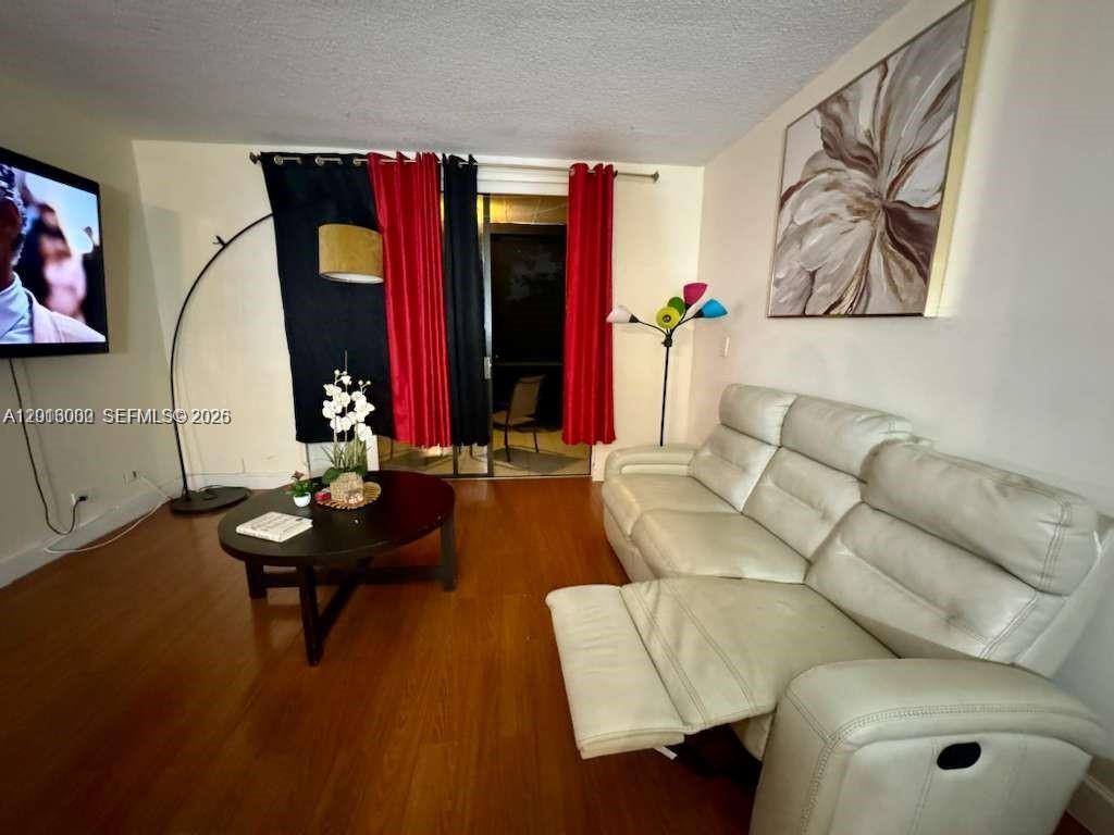 3730 Inverrary Drive, Unit 3B Lauderhill, FL 33319 - Photo 32 of 50 a living room with furniture and a mirror