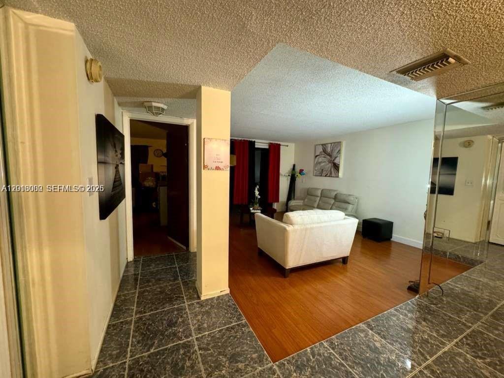3730 Inverrary Drive, Unit 3B Lauderhill, FL 33319 - Photo 33 of 50 a living room with furniture and a rug