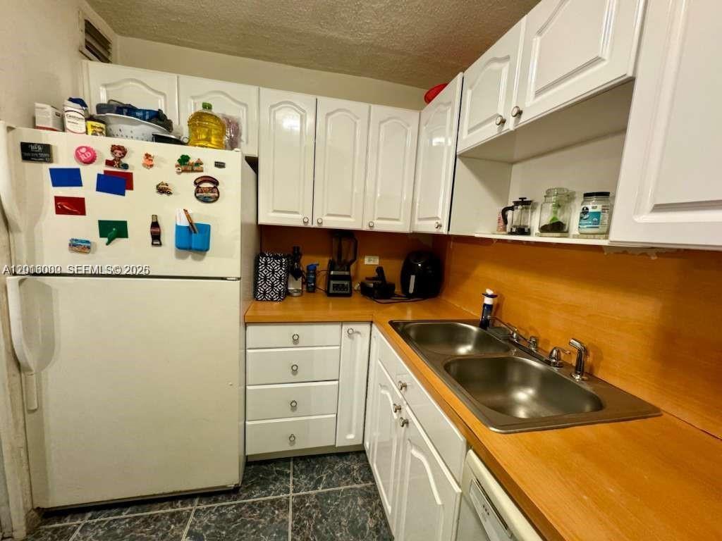 3730 Inverrary Drive, Unit 3B Lauderhill, FL 33319 - Photo 34 of 50 a kitchen with stainless steel appliances a sink a refrigerator and cabinets