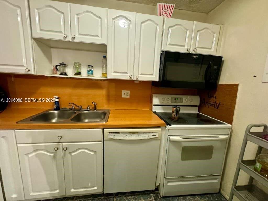 3730 Inverrary Drive, Unit 3B Lauderhill, FL 33319 - Photo 36 of 50 a utility room with stainless steel appliances granite countertop a sink and a microwave