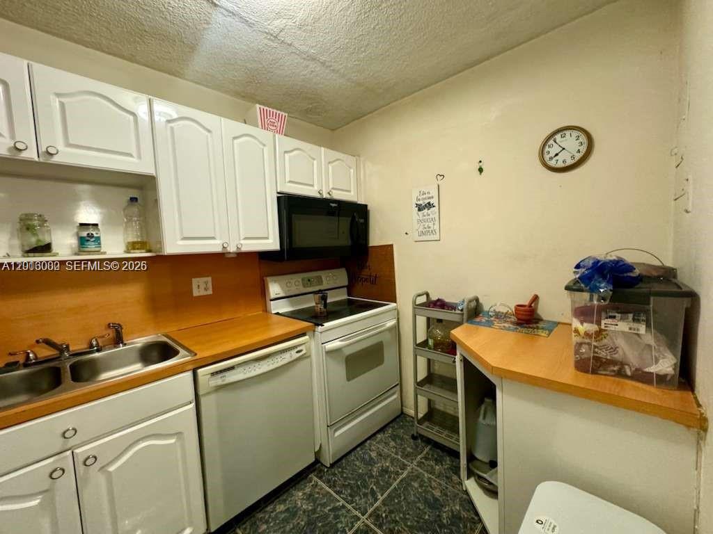 3730 Inverrary Drive, Unit 3B Lauderhill, FL 33319 - Photo 37 of 50 a kitchen with a sink cabinets and appliances
