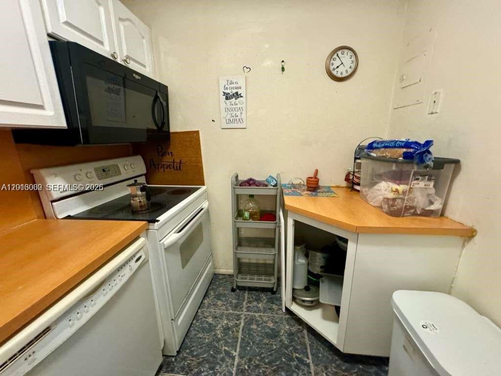 3730 Inverrary Drive, Unit 3B Lauderhill, FL 33319 - Photo 38 of 50 a kitchen with a stove and a microwave