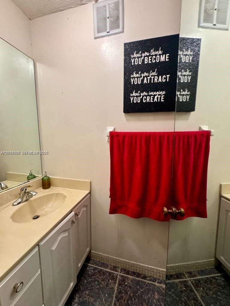 3730 Inverrary Drive, Unit 3B Lauderhill, FL 33319 - Photo 40 of 50 a bathroom with a sink and a mirror