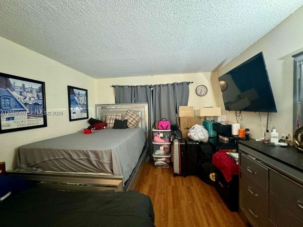 3730 Inverrary Drive, Unit 3B Lauderhill, FL 33319 - Photo 41 of 50 a bedroom with a bed and flat screen tv