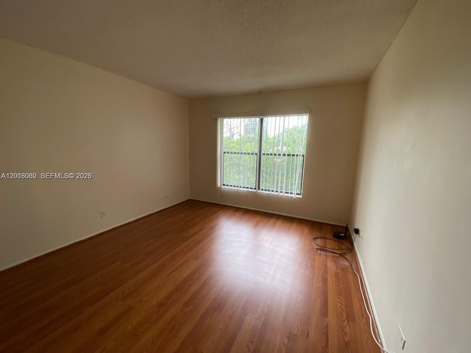 3730 Inverrary Drive, Unit 3B Lauderhill, FL 33319 - Photo 44 of 50 an empty room with wooden floor and windows
