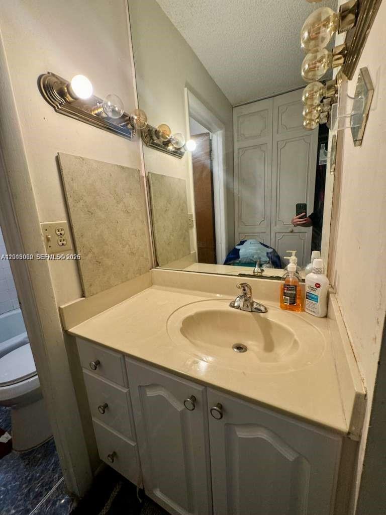 3730 Inverrary Drive, Unit 3B Lauderhill, FL 33319 - Photo 46 of 50 a bathroom with a sink and a mirror