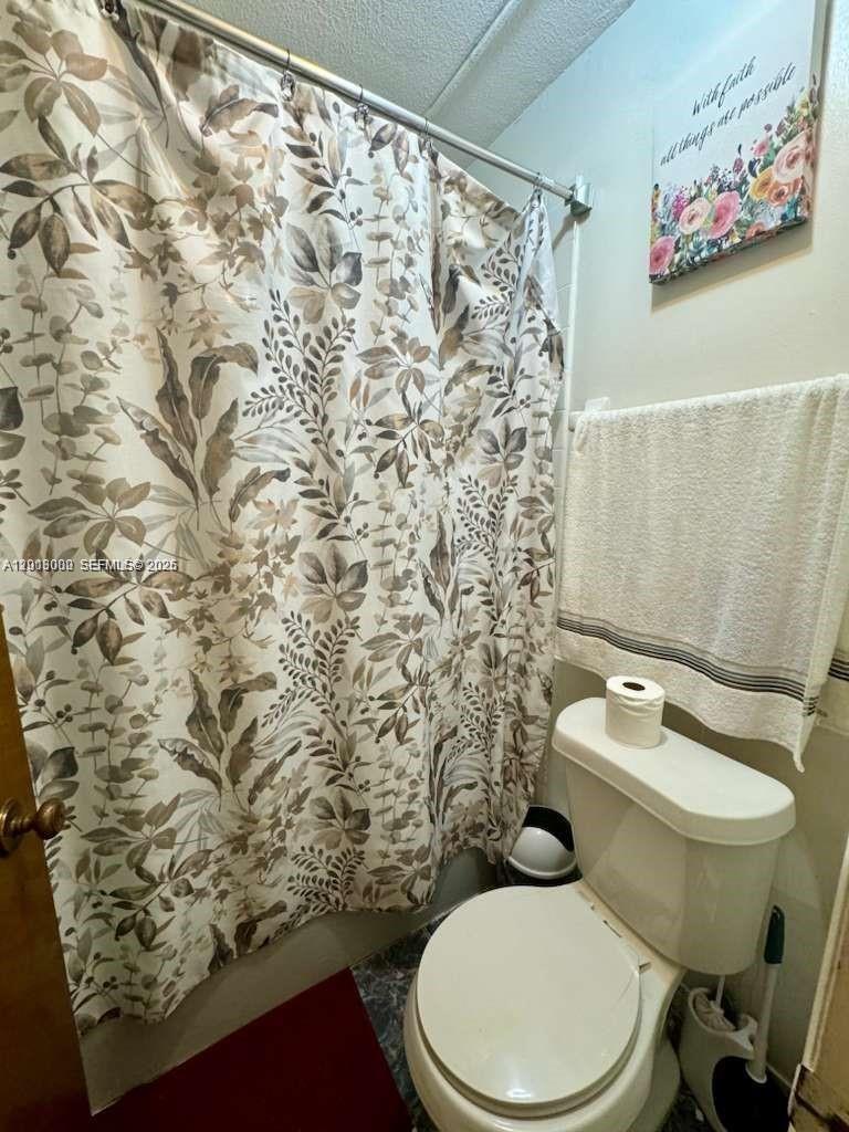 3730 Inverrary Drive, Unit 3B Lauderhill, FL 33319 - Photo 47 of 50 a white toilet sitting next to a shower curtain
