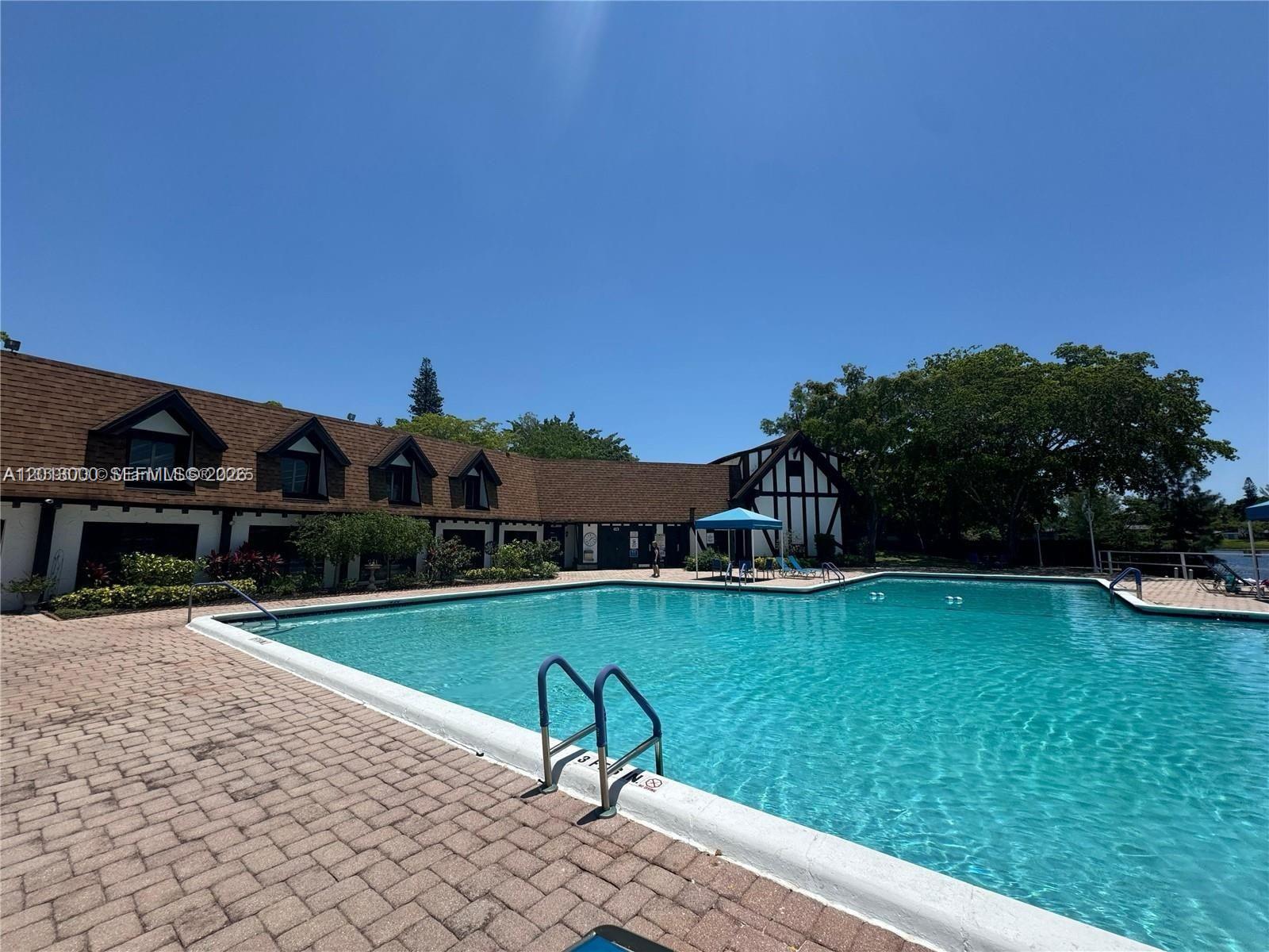3730 Inverrary Drive, Unit 3B Lauderhill, FL 33319 - Photo 9 of 50 a view of a swimming pool with a garden and plants