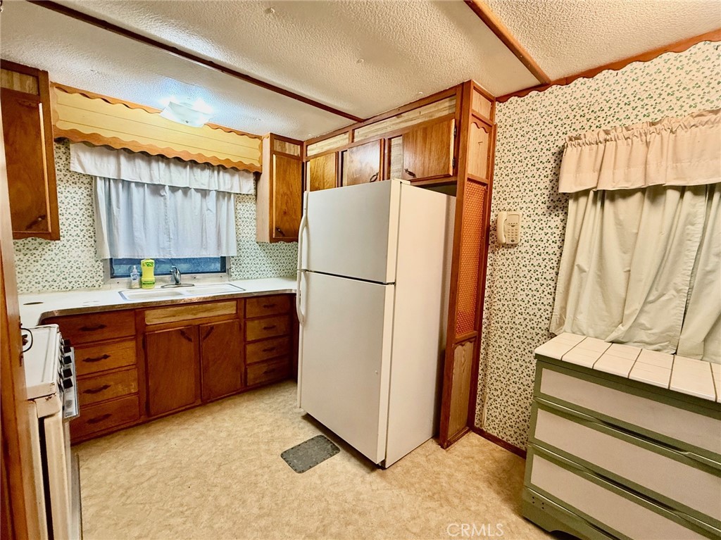 11694 Old Spruce Grove Road Lower Lake, CA 95457 - Photo 43 of 55 a kitchen with stainless steel appliances granite countertop a refrigerator a stove and a sink with wooden floor