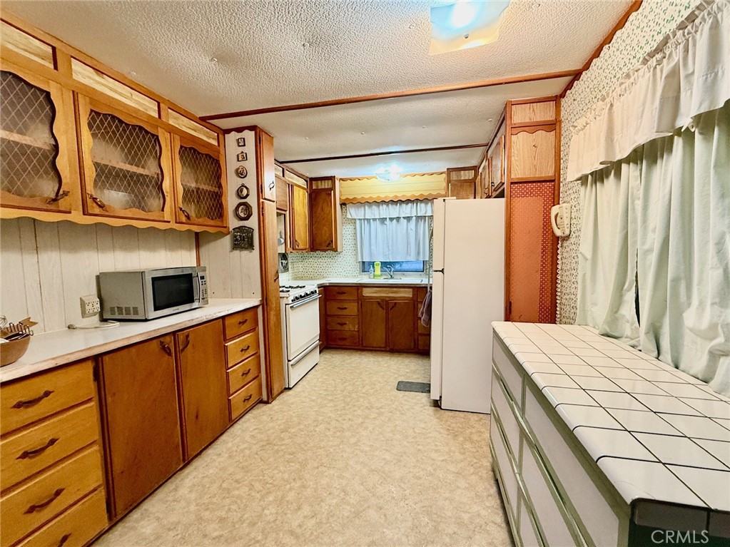 11694 Old Spruce Grove Road Lower Lake, CA 95457 - Photo 44 of 55 a kitchen with stainless steel appliances a sink and a refrigerator