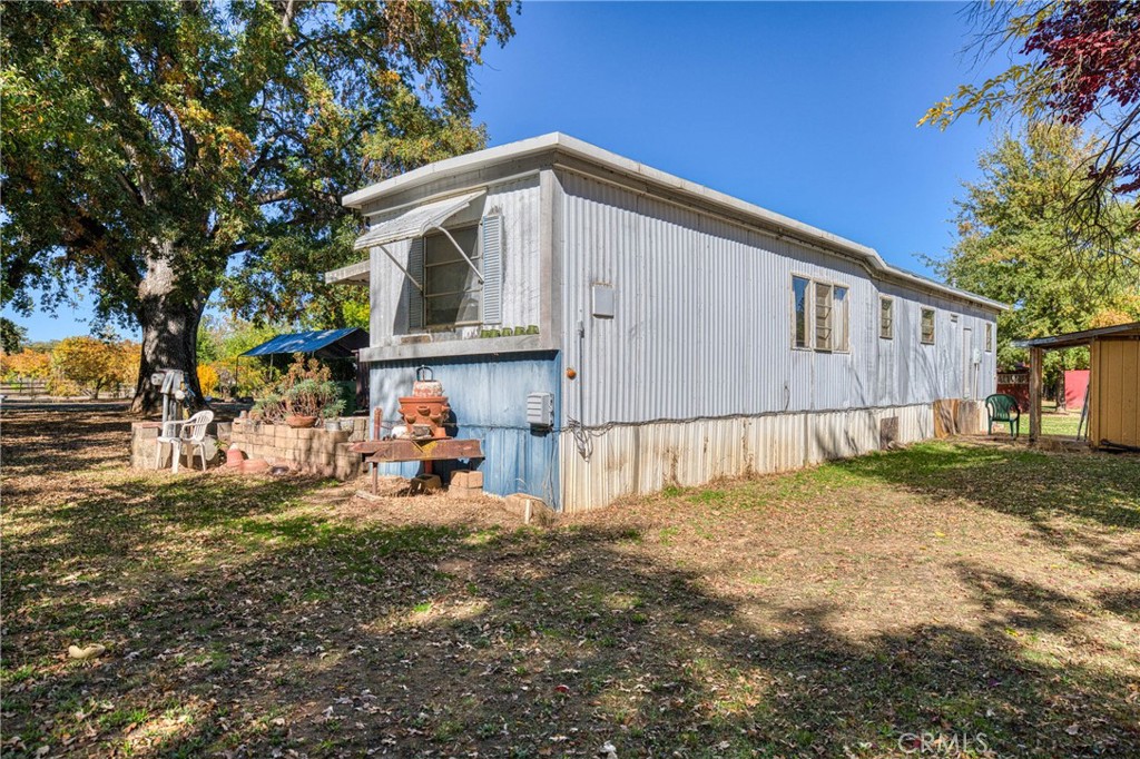 11694 Old Spruce Grove Road Lower Lake, CA 95457 - Photo 7 of 55 a view of a house with backyard and sitting area