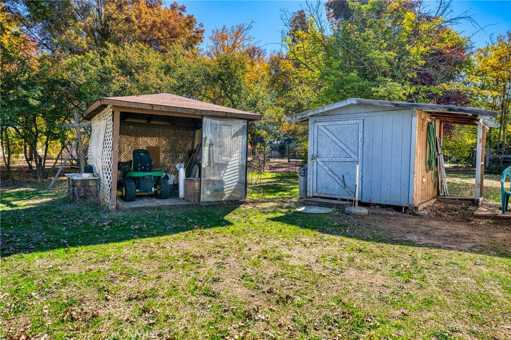 11694 Old Spruce Grove Road Lower Lake, CA 95457 - Photo 10 of 55 a backyard of a house with barbeque oven fire pit table and chairs