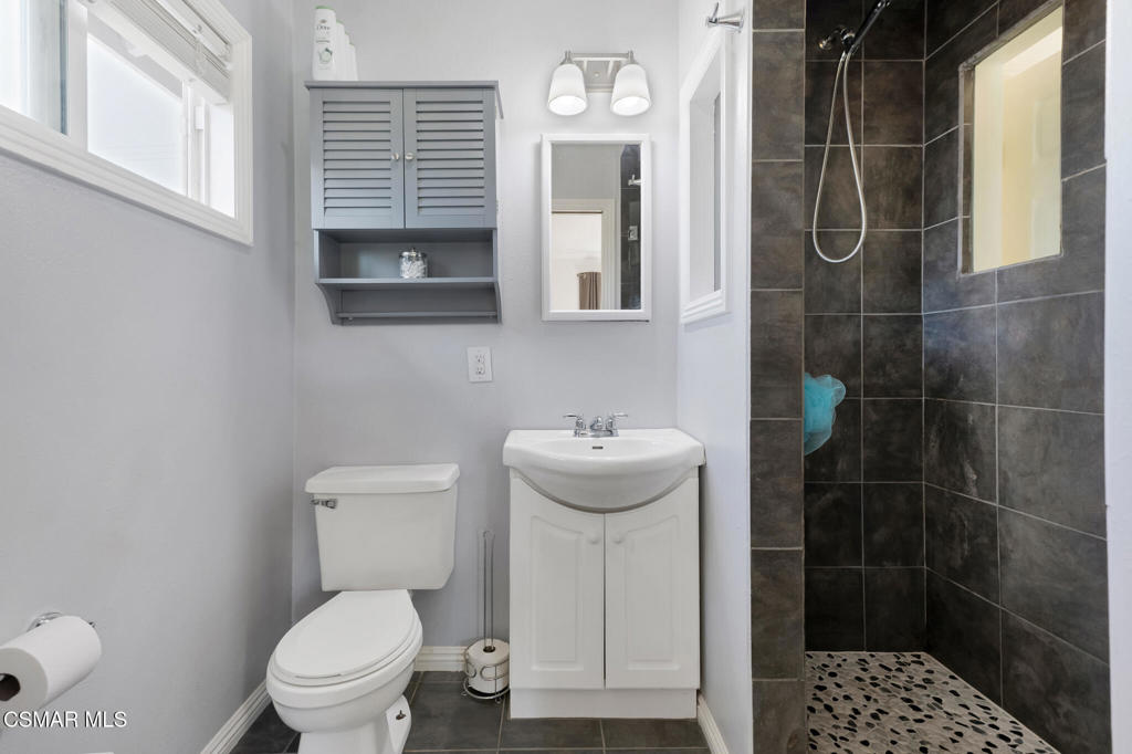 2141 Fitzgerald Road Simi Valley, CA 93065 - Photo 14 of 20 a bathroom with a toilet sink and shower