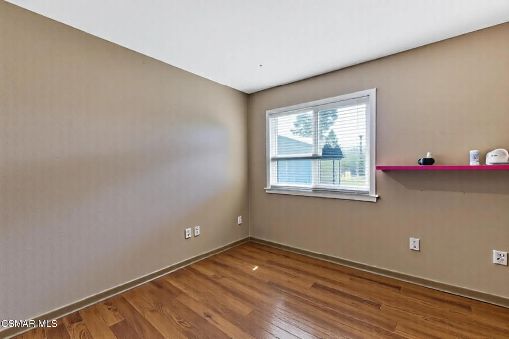 2141 Fitzgerald Road Simi Valley, CA 93065 - Photo 9 of 20 a view of an empty room with wooden floor and a window
