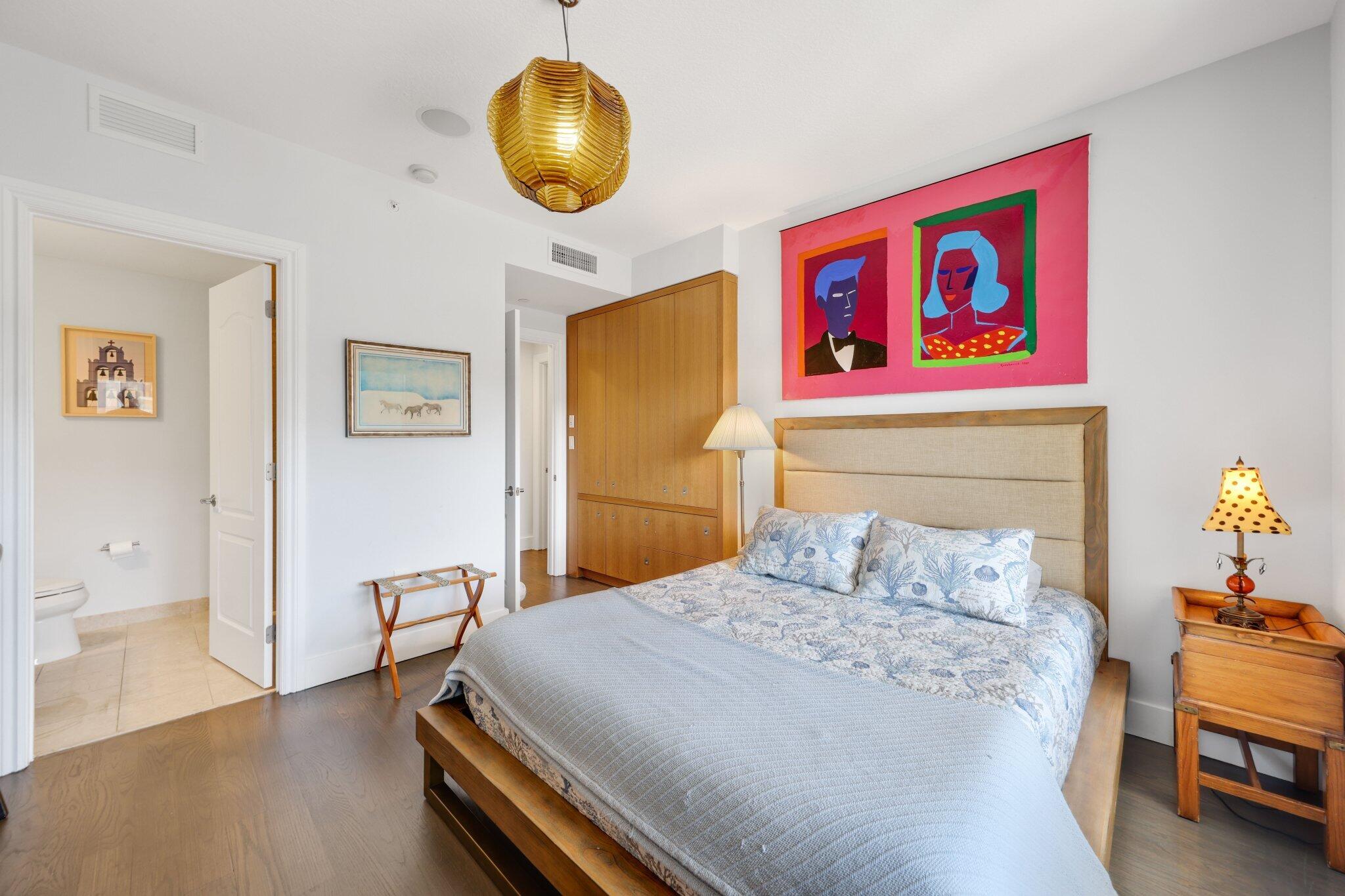 200 East Palmetto Park Road, Unit 7 Boca Raton, FL 33432 - Photo 22 of 58 a bedroom with a bed and wooden floor