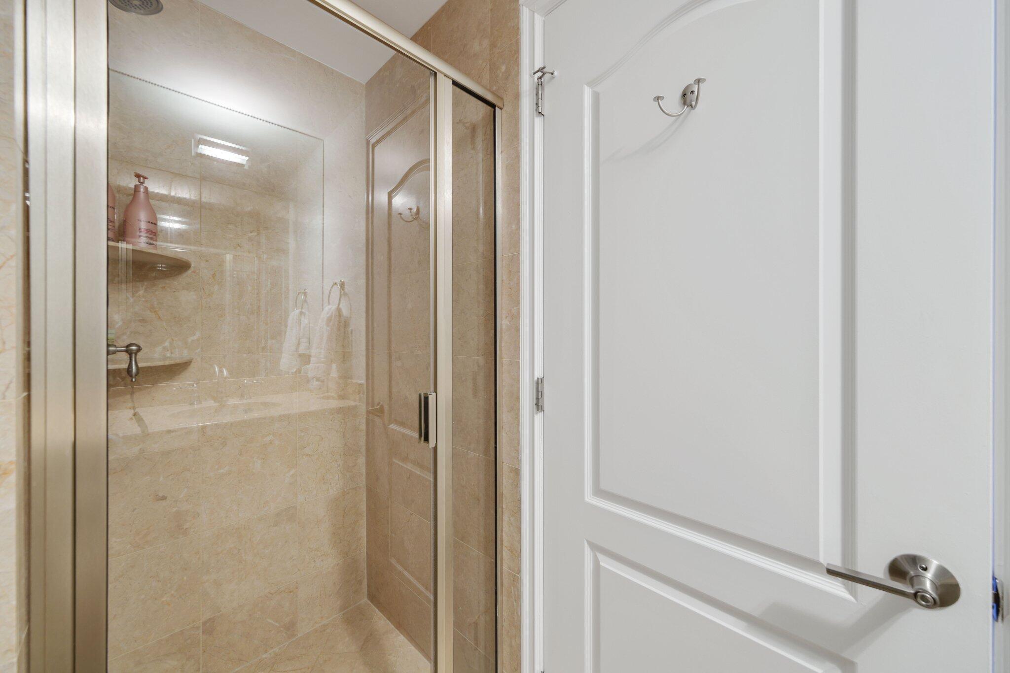 200 East Palmetto Park Road, Unit 7 Boca Raton, FL 33432 - Photo 24 of 58 a bathroom with a glass shower door