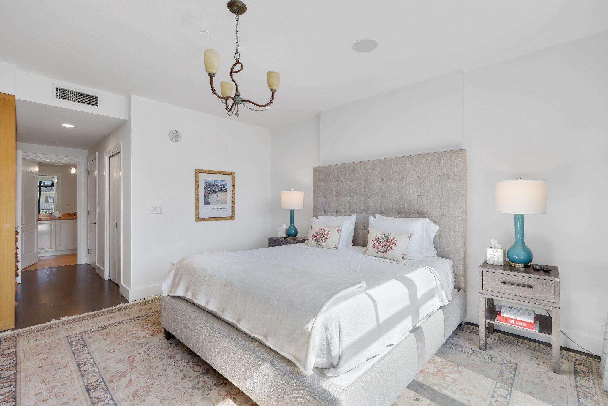 200 East Palmetto Park Road, Unit 7 Boca Raton, FL 33432 - Photo 27 of 58 a bedroom with a bed and a chandelier