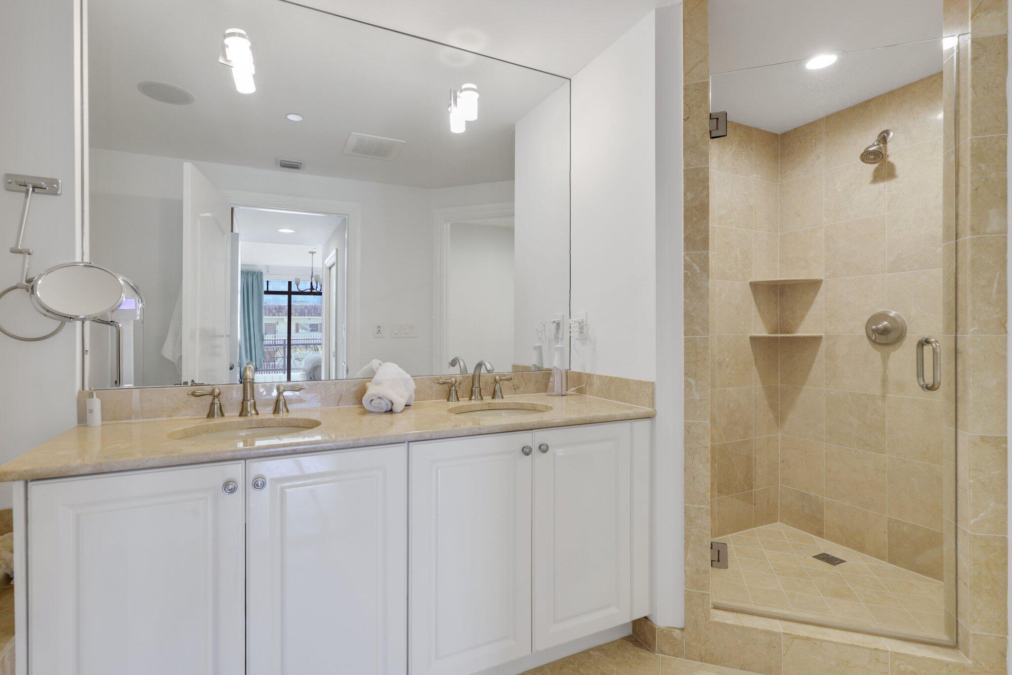 200 East Palmetto Park Road, Unit 7 Boca Raton, FL 33432 - Photo 30 of 58 a bathroom with a granite countertop sink a mirror and a shower