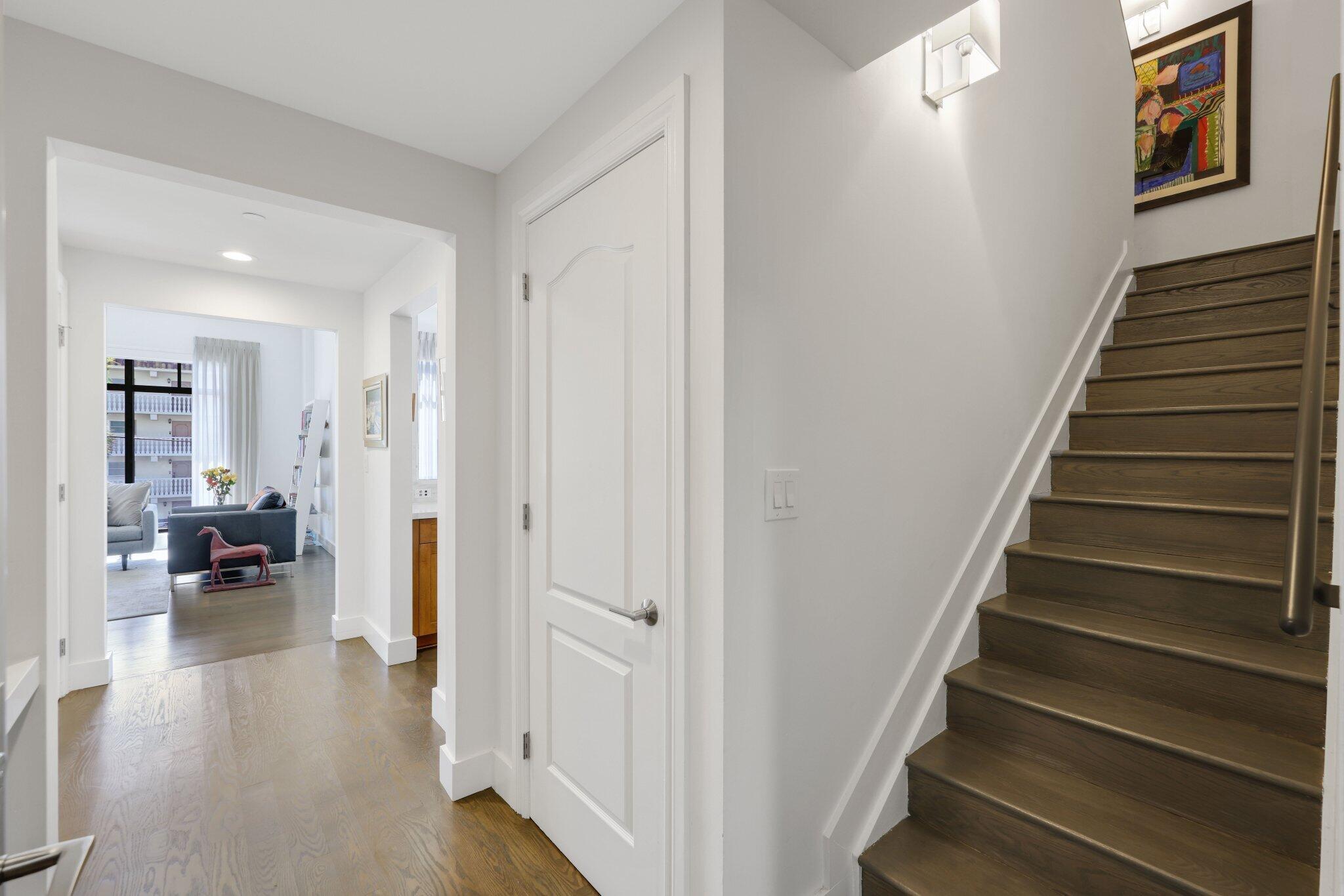 200 East Palmetto Park Road, Unit 7 Boca Raton, FL 33432 - Photo 3 of 58 a view of a livingroom with wooden floor and stairs