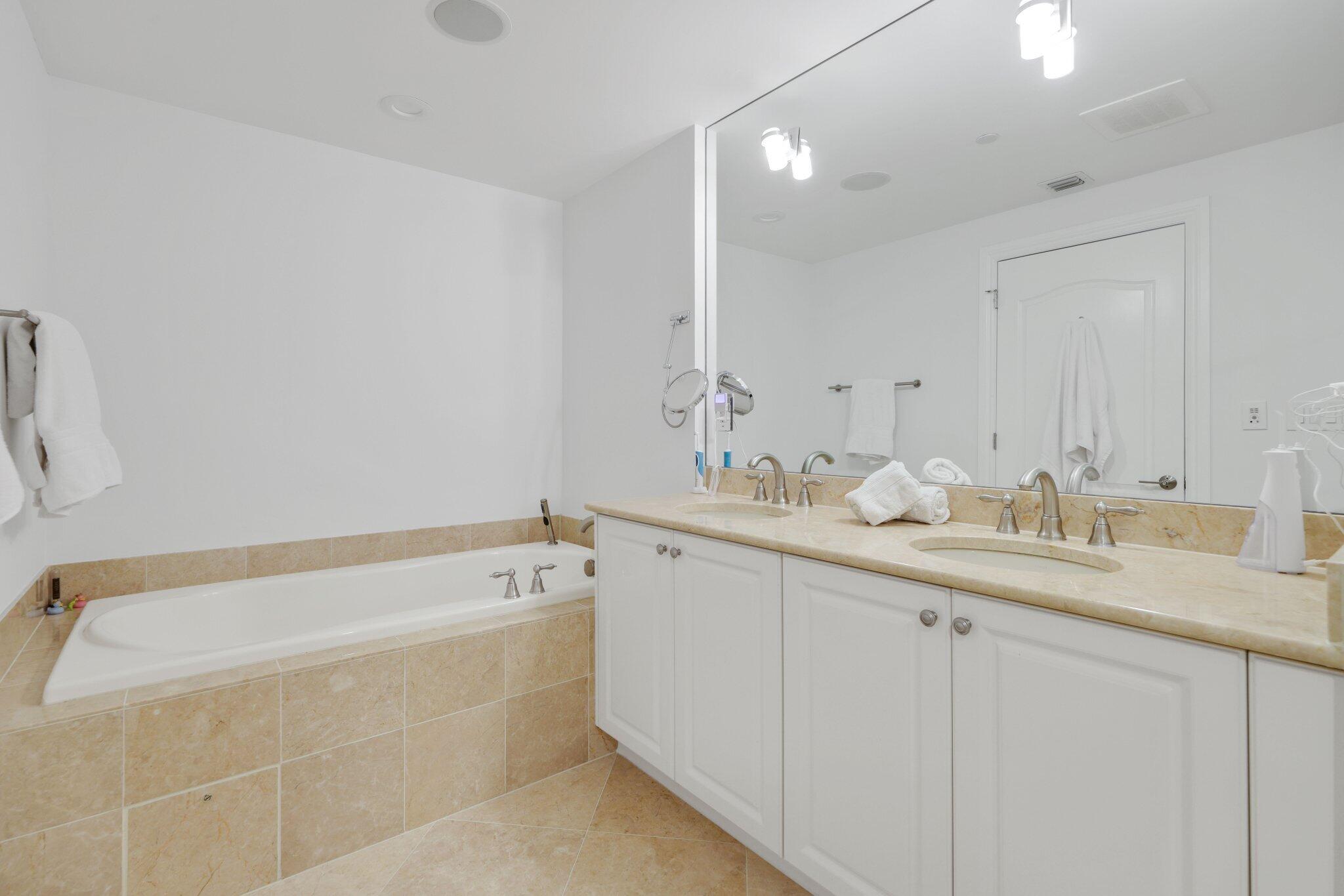 200 East Palmetto Park Road, Unit 7 Boca Raton, FL 33432 - Photo 31 of 58 a spacious bathroom with a tub sink and mirror