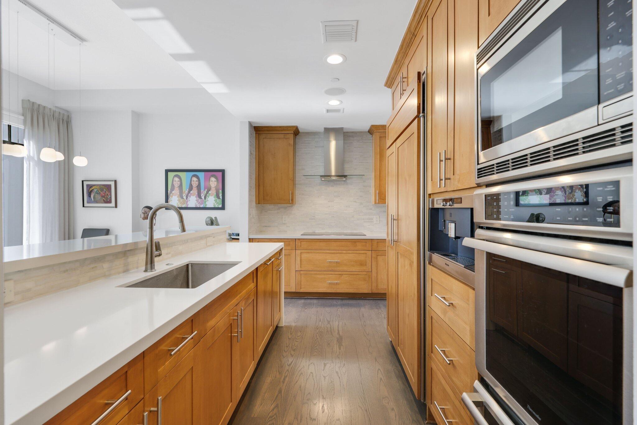 200 East Palmetto Park Road, Unit 7 Boca Raton, FL 33432 - Photo 5 of 58 a kitchen with stainless steel appliances granite countertop a sink and a refrigerator