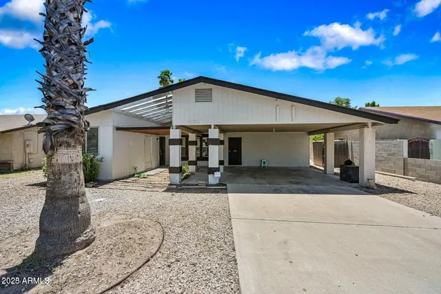 a front view of a house with yard patio and outdoor seating