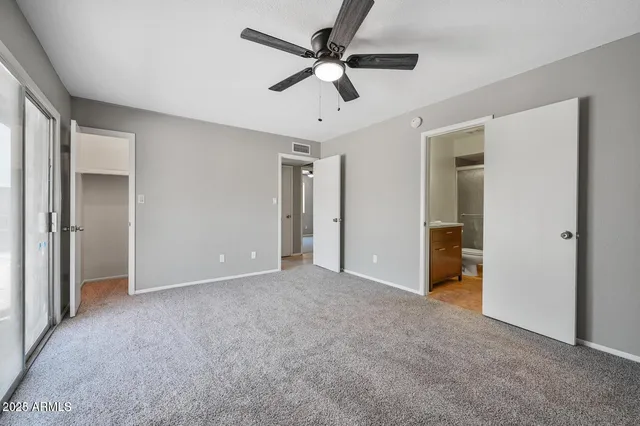 a view of an empty room with a ceiling fan